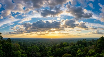 Obraz premium Spectacular View of a Tropical Rainforest at Sunset with Cloudy Sky
