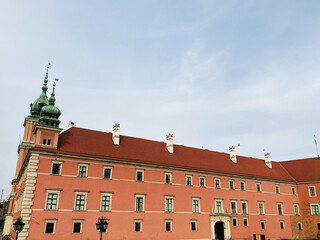 Obraz premium Historical building with red roof in Warsaw, Poland on a sunny day