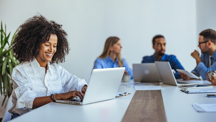 Collaborative Team Meeting with Focused Professionals in a Modern Work Environment