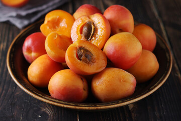 Fresh ripe apricots in bowl in rustic style
