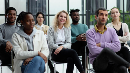 conducts business training with a group of young people.