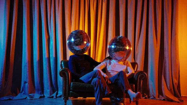 couple with disco ball heads sitting on the couch, blue and orange tones, festive , curtain background, retro party vibes, surreal 70s theme, funky holiday card with copy space  