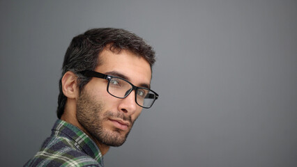 Obraz premium Portrait of a handsome middle aged man posing against a gray background.