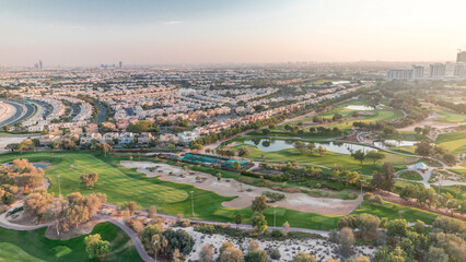 Aerial view to villas and houses with Golf course with green lawn and lakes timelapse