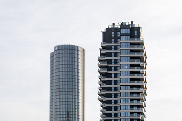 Fototapeta premium Modern Urban Skyscrapers with Glass Facades and Balconies in a City Landscape