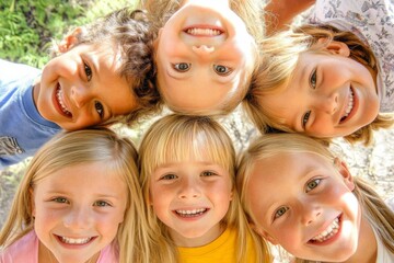 Fototapeta premium Top-down view of diverse group of six smiling children outdoors in a circle, wearing casual clothes with trees in background