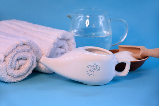 White ceramic Neti pot for nasal cleansing stock photo images. Nasal irrigation tools on a blue background stock images. Nasal care still life photo stock. Jala neti nose cleaning images