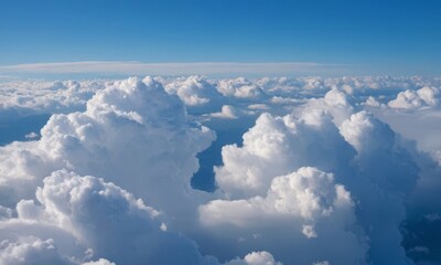 Fototapeta premium Majestic aerial view of cumulus clouds under a clear blue sky expanse