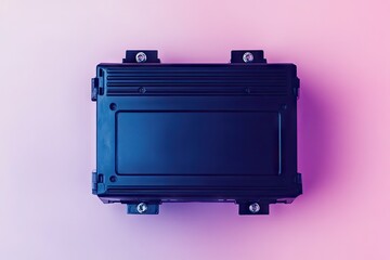 Dark-colored rectangular electronic box, likely a control unit, sits atop a gradient background