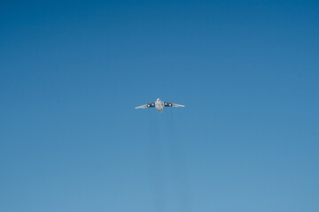 A plane is soaring gracefully and majestically through a vast and clear blue sky, taking full...