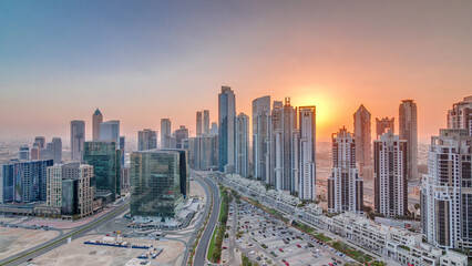 Modern residential and office complex with many towers aerial timelapse at Business Bay, Dubai, UAE.