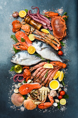 Background filled with fresh fish, lobsters, seafood and shellfish. Vertical photo. Top view. © Yaruniv-Studio