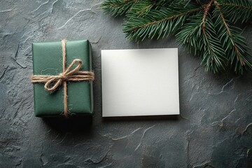 Blank Card Mockup with Green Gift Box and Pine Branch on Gray Background for Christmas and New Year