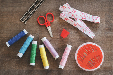 Sewing thread and accessories on rustic wood table