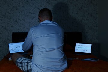 A man on remote access sits on remote access and prepares a strategic report on freight...
