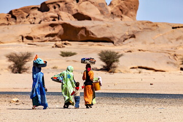 Women are cleaning and washing clothes in the sahara desert
