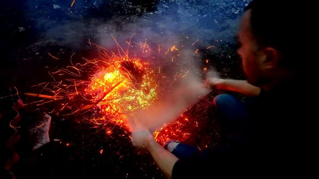 A guy makes fire outside ash danger