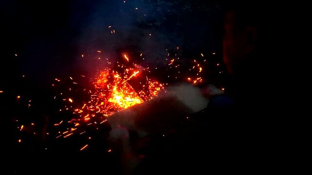 A guy makes fire outside ash danger