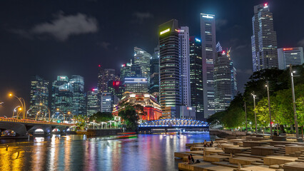 Obraz premium Business Financial Downtown City and Skyscrapers Tower Building at Marina Bay night timelapse hyperlapse, Singapore