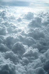 Obraz premium Stunning aerial view of a cloudscape illuminated by sunlight with shades of blue and white