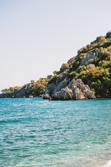 Fototapeta premium Breathtaking coastal landscape with turquoise waters and pine-covered mountains