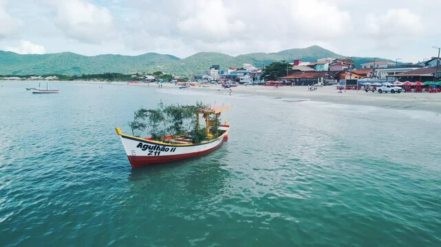 People prepare the boat to celebrate the day of Iemanja, or the day of Our Lady of Navigators. Group of people gather on the beach in Brazil and celebrate. Iemanja is a popular Afro-Brazilian deity