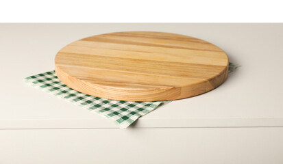 Green checkered napkin and empty wooden board on light table against white background