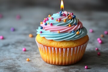 Colorful birthday cupcake with candles on a light background, space for text. Stock photo contest winner, high resolution, professional photography. 