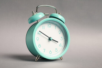 One turquoise alarm clock on grey background
