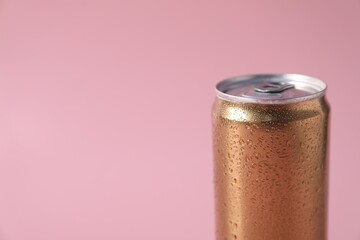 One aluminium can of beverage on pink background, closeup. Space for text