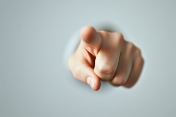 Pointing finger gesture against blurred background shows accusation, blame, or direct selection. Dramatic lighting creates powerful emotional impact.