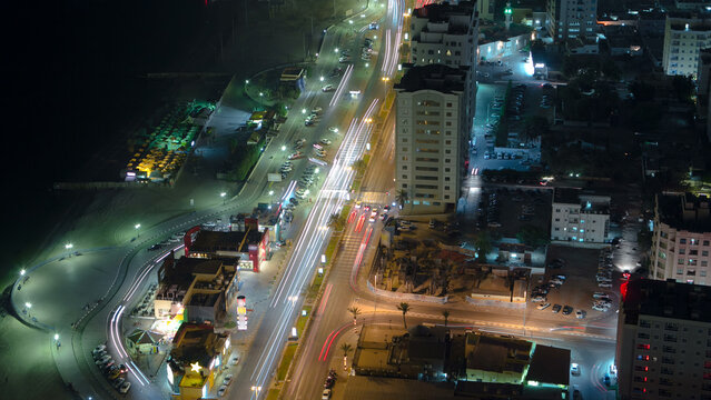 Cityscape of Ajman from rooftop night aerial timelapse