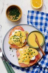 Eggs Benedict with Ham on a Plate for Breakfast.  .Healthy appetizer.