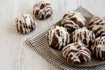 Homemade Profiteroles with Coconut Cream on a Plate, side view.
