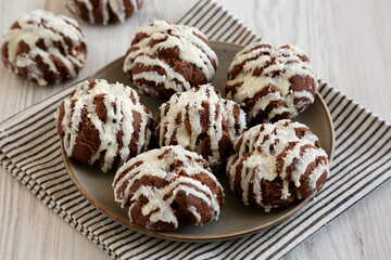 Homemade Profiteroles with Coconut Cream on a Plate, side view.