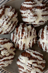 Homemade Profiteroles with Coconut Cream on a Plate, top view.