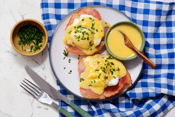 Eggs Benedict with Ham on a Plate for Breakfast.  .Healthy appetizer.