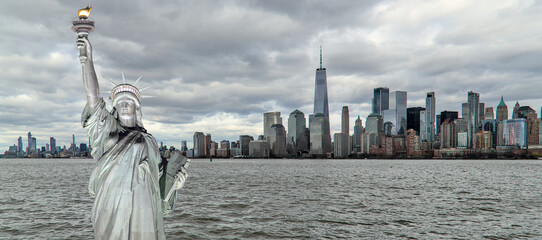 statue of liberty in front of new york city skyline composite photo (lady liberty freedom symbol sculpture built by french) nyc manhattan downtown cityscape harbor waterfront hudson east river © Yuriy T