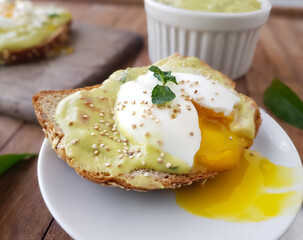 toasted sandwich bread with runny egg yolk and avocado cream and rustic base