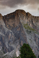Majestic Dolomite peaks rise dramatically under an overcast sky near Seceda, Sankt Christina, and Sankt Ulrich