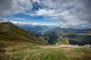 Fototapeta premium Breathtaking view of the Dolomites around Seceda, Sankt Christina, and Sankt Ulrich under a partly cloudy sky