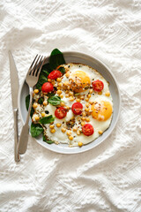 A nutritious and Healthy Breakfast featuring Eggs, fresh Tomatoes, and vibrant Spinach, chickpeas.