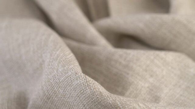 Light beige natural fabric rotate in circle. Linen or cotton. Textile material tissue cloth. Texture fabric close up. Fabric background