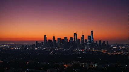 Fototapeta premium Los Angeles city skyline at dusk with dramatic purple and orange sky, panoramic cityscape view of Downtown LA at twilight