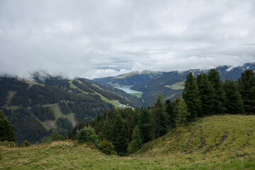 Fototapeta premium Scenic view of Gerlos and Konigsleiten mountains in Austria with cloudy skies and lush green valleys