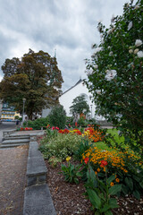 Beautiful flower garden near a church in Mayrhofen Austria under a cloudy sky