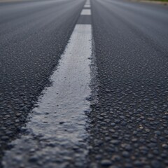 A road with an asphalt texture set against a dark backdrop black