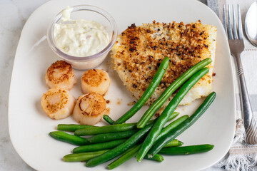 baked haddock served with scallops and green beans