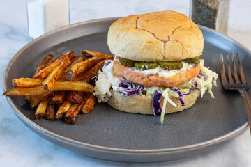 salmon burger served with home made french fries