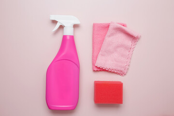 Pink cleaning supplies including spray bottle, sponge, and microfiber cloths. Household cleaning...
